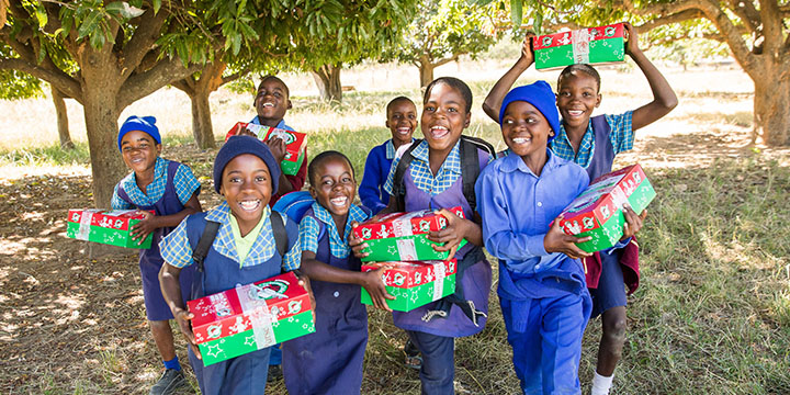 Happy group of children with shoebox gifts in Zimbabwe