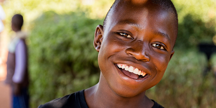 Boy holding The Greatest Journey book in Zimbabwe