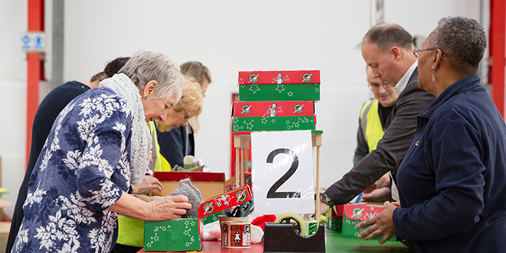 Group of volunteers processing shoebox gifts