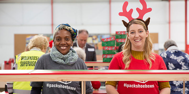 Volunteers processing shoebox gifts near Christmas