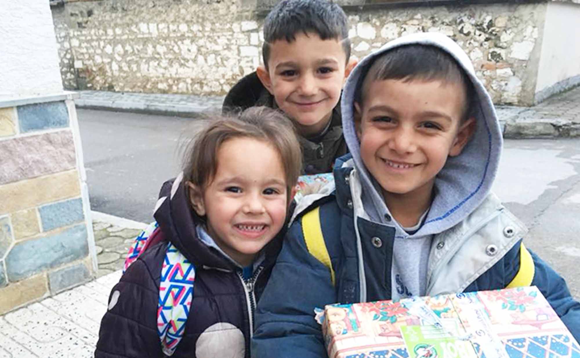 Children holding shoebox gifts