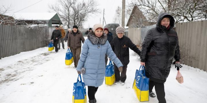 women with food parcels in Ukraine