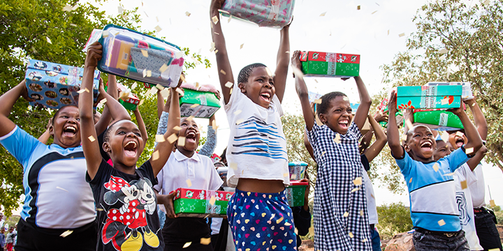 Children celebrating receiving shoebox gifts
