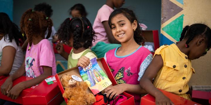 Girl smiles with shoebox gift