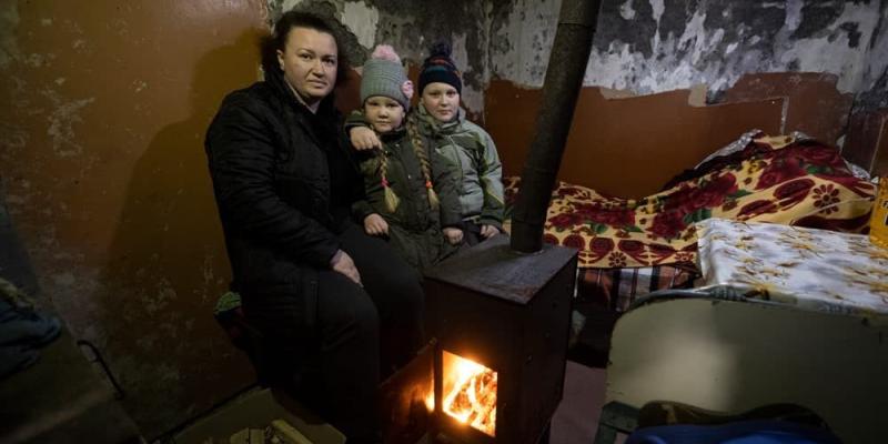 Families huddle in their cellars during shelling. Our stoves provide needed warmth.
