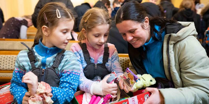 Seven-year-old Daryna* and 9-year-old Kalyna* were pleased with their shoebox gifts. Daryna held up her stuffed grey cat with joy and Kalyna treasured her stuffed green frog.