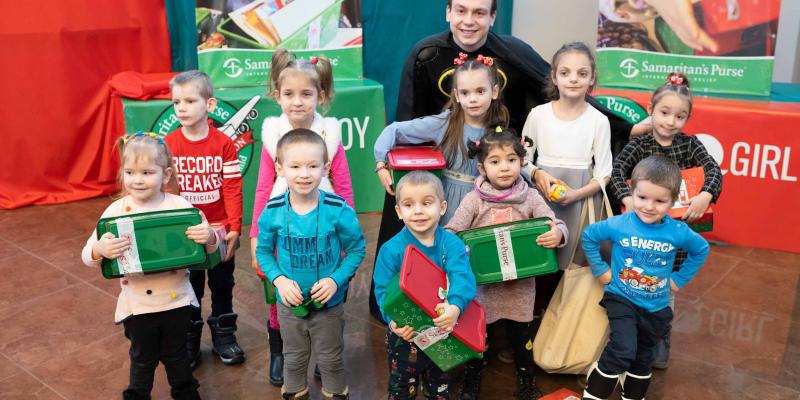 Group of children holding shoebox gifts