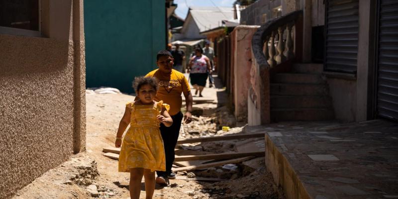 The Peña family walks to their apartment.