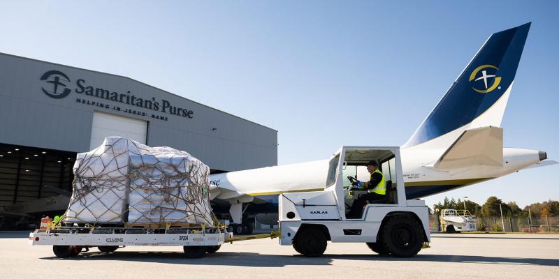 Outside Samaritan’s Purse hangar in Greensboro, staff loaded onto the plane plastic tarpaulin, solar lights, buckets, and household water filters for 3,200 families