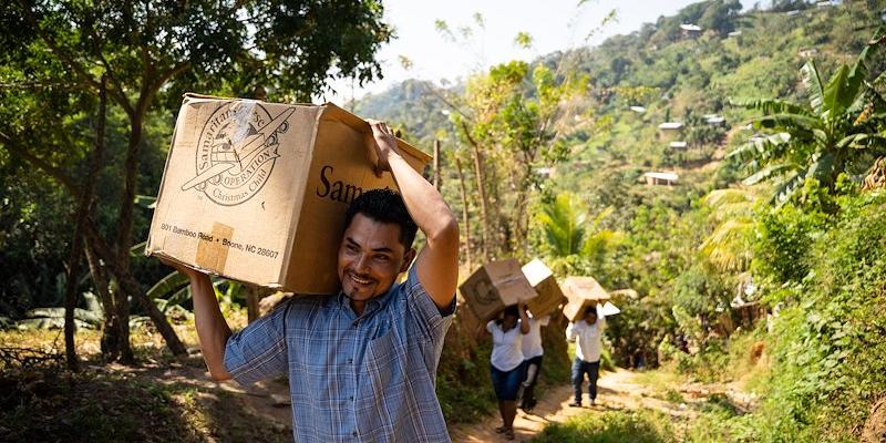 Cartons of shoeboxes being transported up the hills