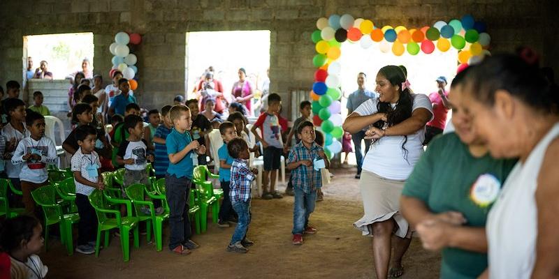 Children join in, using actions to sing along to songs