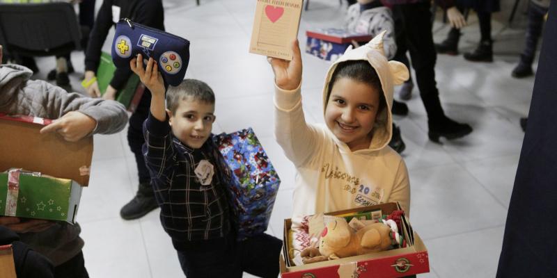 children hold up their favourite gifts