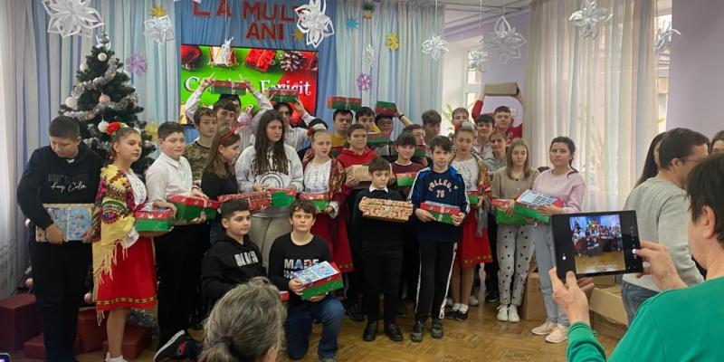 Group of children holding shoebox gifts