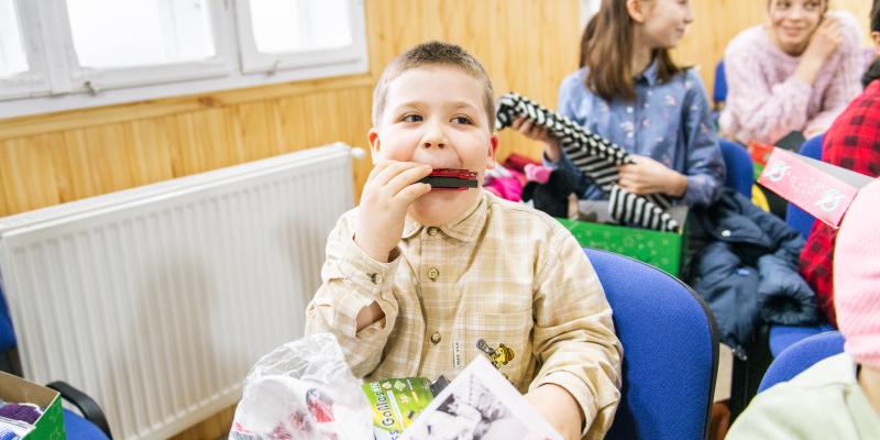 boy playing harmonica