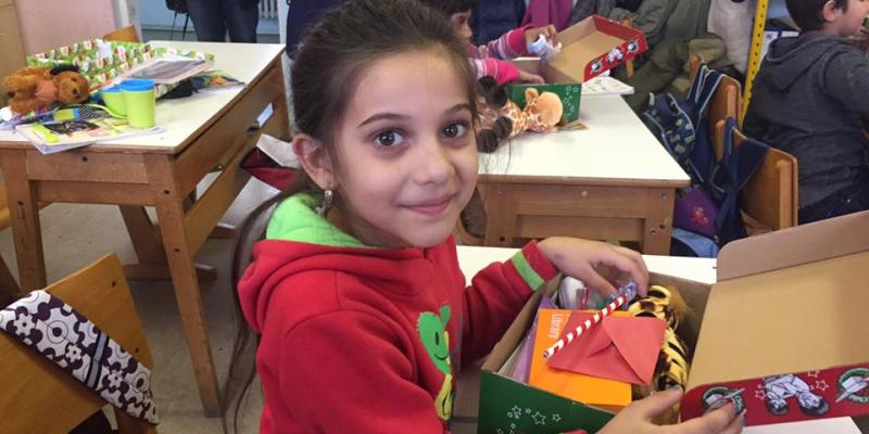 girl smiles with shoebox