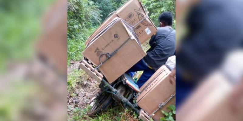 The dirt bike toppled over from the weight of the cartons about 15 times every half mile of the trek.