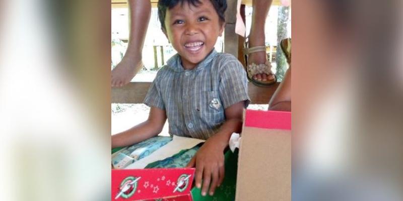 A boy overflows with joy as he opens the shoebox gift packed just for him by a caring individual from around the world.