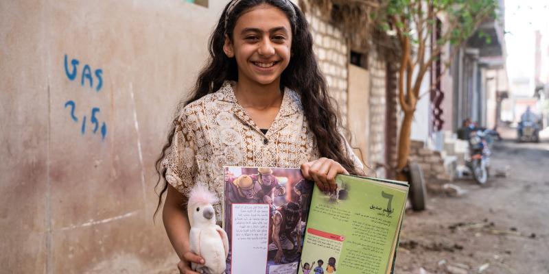 Girl smiling with gifts in hand