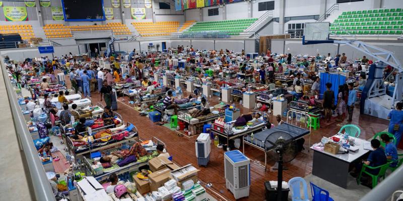 Nearly 100 injured patients wait inside a stadium in Naypyidaw for surgery.