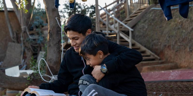 Johan studies the Word of God with his younger brother, Samuel.
