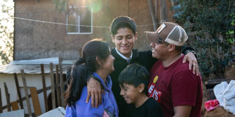 Johan (centre) embraces his family.