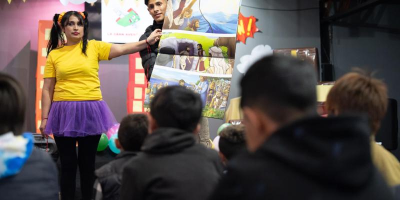 Johan and his mother, Zuly, present the Gospel to boys and girls who are about to receive shoebox gifts.