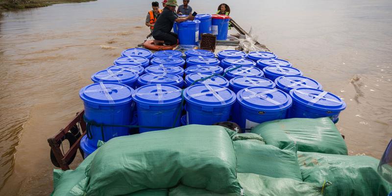 A boatful of Samaritan’s Purse relief supply kits makes its way across the river to a remote island village in central Vietnam.