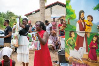 THE GOSPEL is shared during an outreach event.