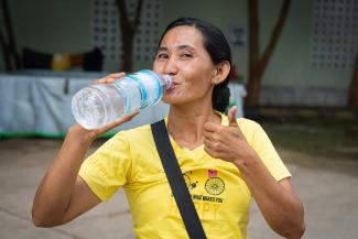Kyi enjoys a taste of the fresh filtered water from Samaritan’s Purse.