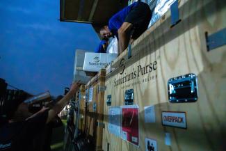 Disaster response specialists work late into the night to set up the Emergency Field Hospital.