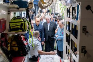 Franklin Graham, Pastor Greg Laurie, left, and Ambassador Huckabee meet with a first responder as he shows them inside the 20th vehicle we provided for Magen David Adom’s fleet.