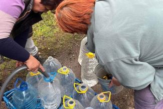 Eastern Ukrainians bring their bottles to be filled with the precious water delivered by Pastor Yehven and his team.