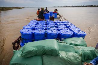 A boatful of Samaritan’s Purse relief supply kits makes its way across the river to a remote island village in central Vietnam.