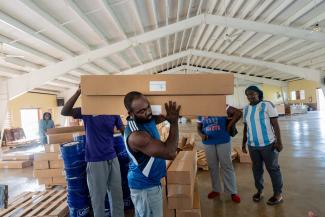 Volunteers and church partners work together at a Samaritan’s Purse distribution site in Jamaica to prepare emergency shelter materials for families affected by Hurricane Melissa.