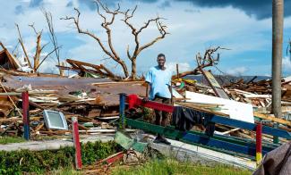 Anthony Anderson stands amid the rubble of what was once his home in Black River, Jamaica. He survived Hurricane Melissa after being trapped beneath debris for hours.