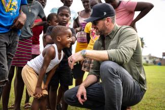 Children joyfully greet Graham during his visit to one of our distribution areas.