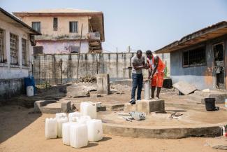 Prince helps with a well maintenance project, repairing the hand pump.