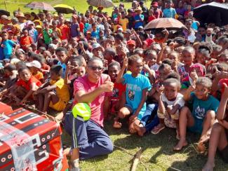 Children and interested family members wait in expectation before the Gospel of Jesus Christ is presented at the outreach event.