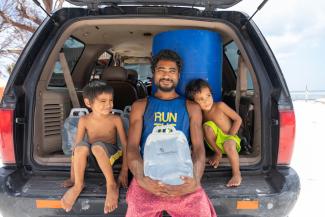 Fernando and his sons were grateful to get jerry cans full of water.