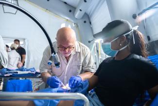 A member of our medical team treats Mariana’s injuries at the Emergency Field Hospital.