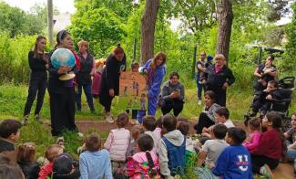 In a village outside Tbilisi, Georgia, children attentively listen at an Operation Christmas Child outreach event, thanks in part, to a globe.