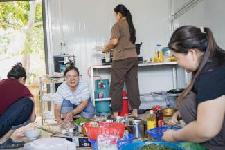 Among other relief supplies, Tu (second from left) received rice and canned meat to help feed her family.