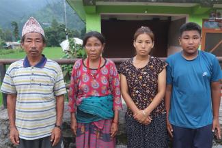 Maya, second from left, lost nine family members. Only her husband, daughter, and grandchild survived.