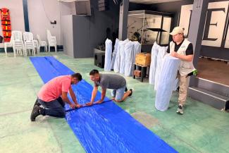 The tarps were cut and distributed in local churches.