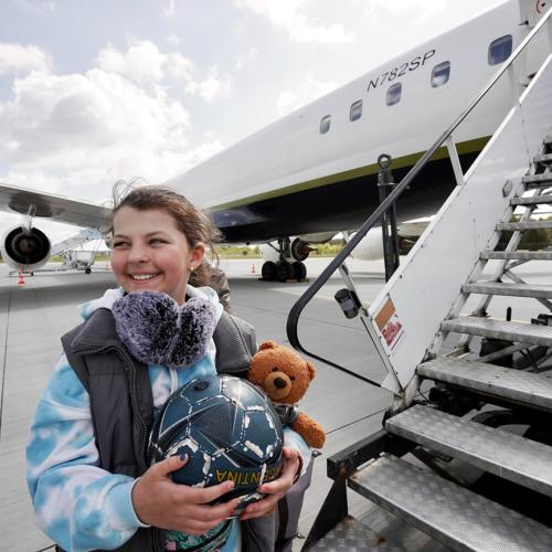 girl getting on plane