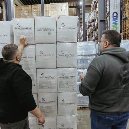 In a warehouse in Lebanon, team members tally boxes of jerry cans that arrived on the airlifts prior to distributing them to families in need.