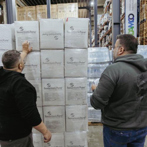 In a warehouse in Lebanon, team members tally boxes of jerry cans that arrived on the airlifts prior to distributing them to families in need.