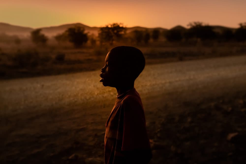 Himba child looking toward sunrise