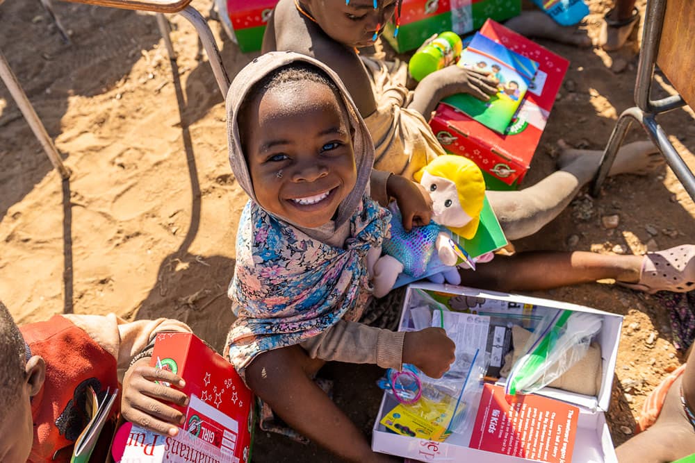 A little girl opens her gift