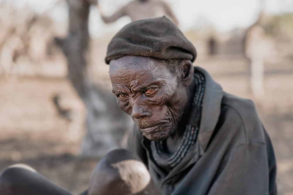 Himba man sitting and looking to his left